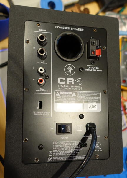 back of powered speaker showing screws removed